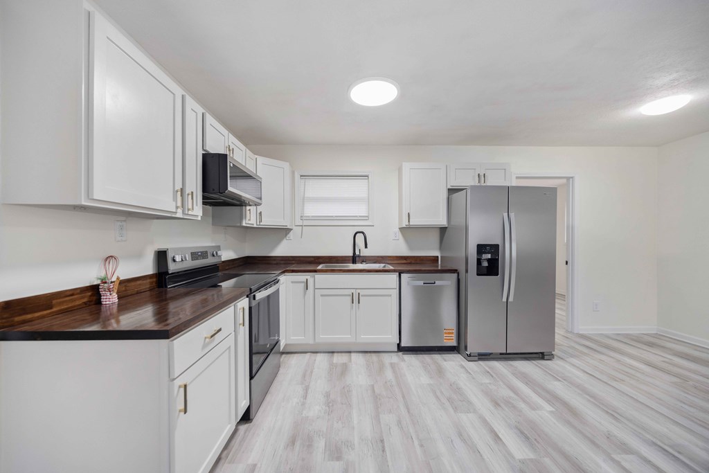 6270 Mill Branch Road Columbus, GA 31907 - Photo 7 of 25 a kitchen with stainless steel appliances granite countertop a sink stove and refrigerator