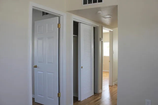 a view of walk in closet with empty racks