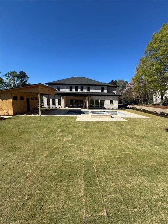 3425 Thompson Mill Road Buford, GA 30519 - Photo 21 of 48 a view of a swimming pool with an outdoor space and seating area