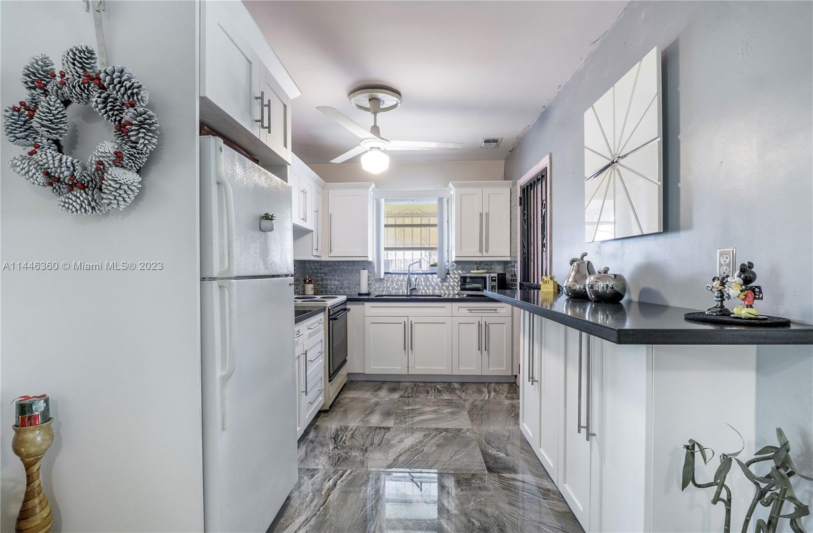 2446 Southwest 15th Street Miami, FL 33145 - Photo 11 of 42 a kitchen with a refrigerator and a sink