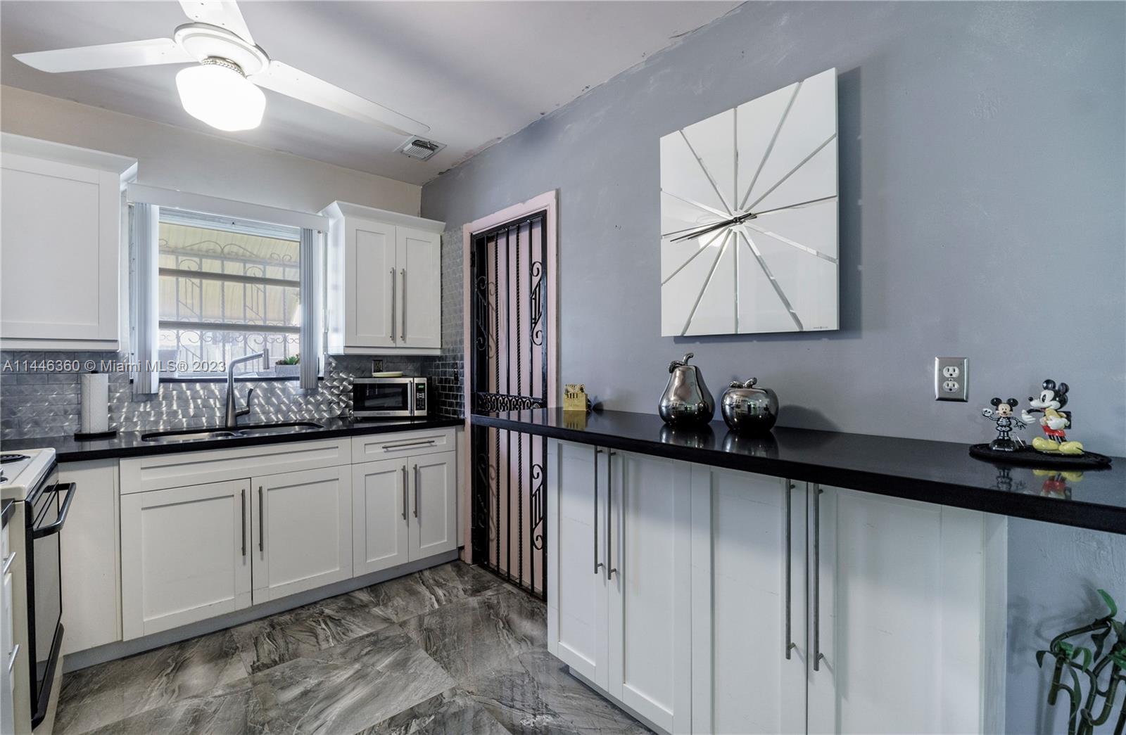 2446 Southwest 15th Street Miami, FL 33145 - Photo 13 of 42 a kitchen with sink cabinets and window