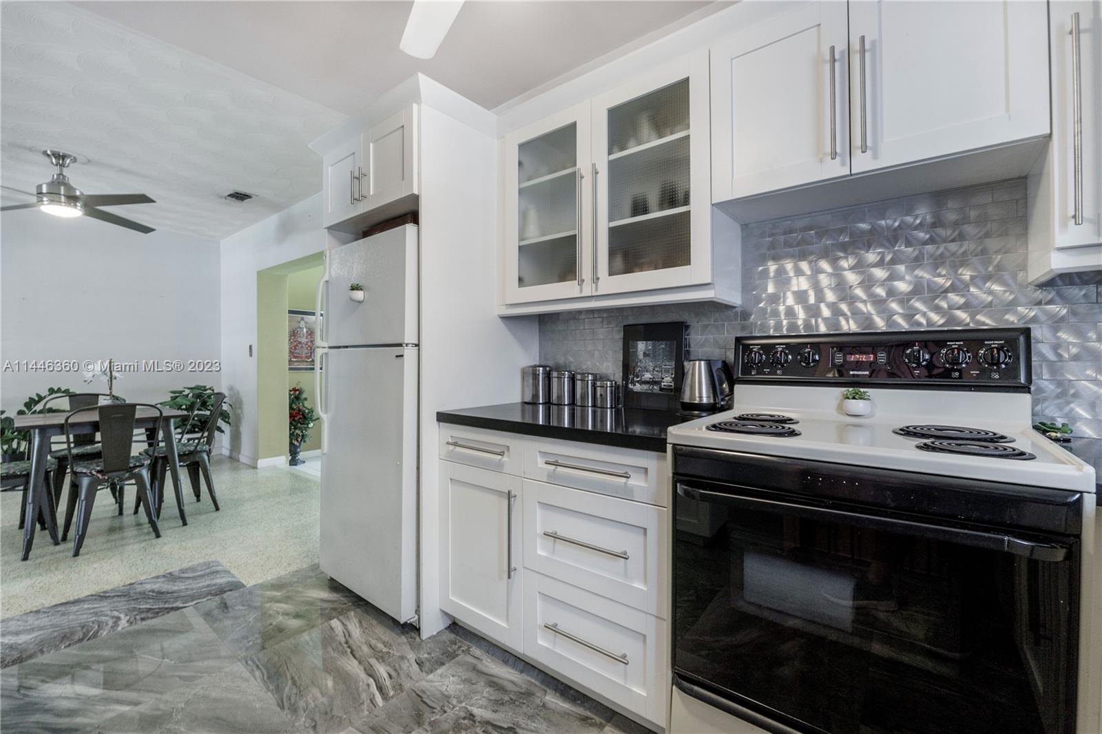2446 Southwest 15th Street Miami, FL 33145 - Photo 14 of 42 a kitchen with a stove and white cabinets