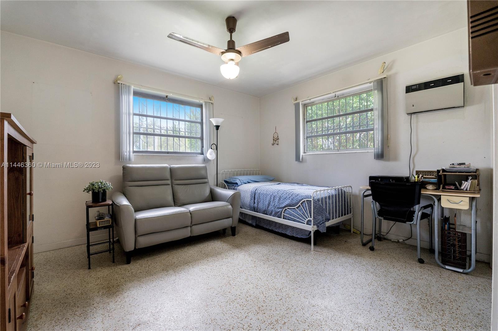 2446 Southwest 15th Street Miami, FL 33145 - Photo 17 of 42 a spacious bedroom with a bed a couch and a window