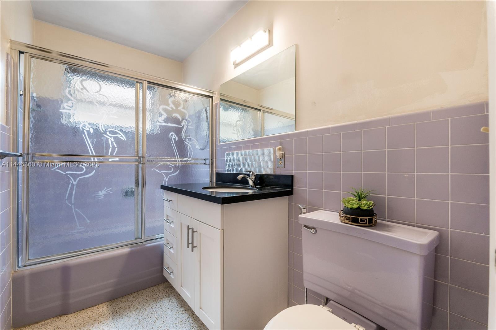 2446 Southwest 15th Street Miami, FL 33145 - Photo 19 of 42 a bathroom with a granite countertop sink a toilet and shower