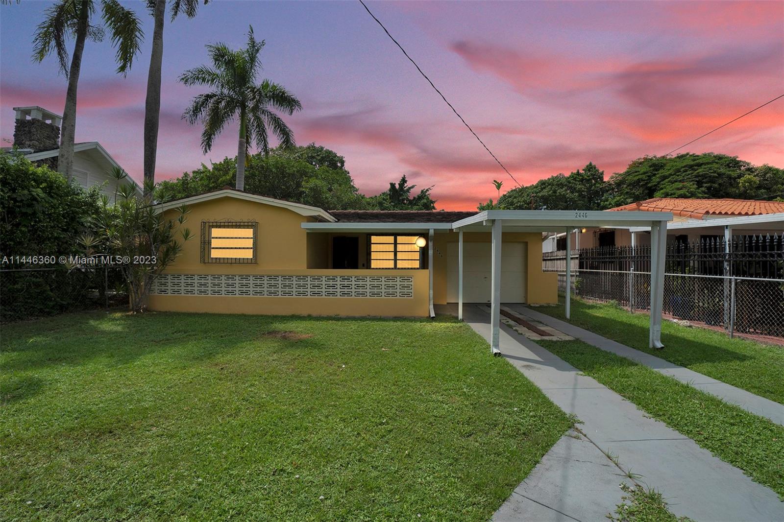 2446 Southwest 15th Street Miami, FL 33145 - Photo 2 of 42 a front view of a house with a garden and yard