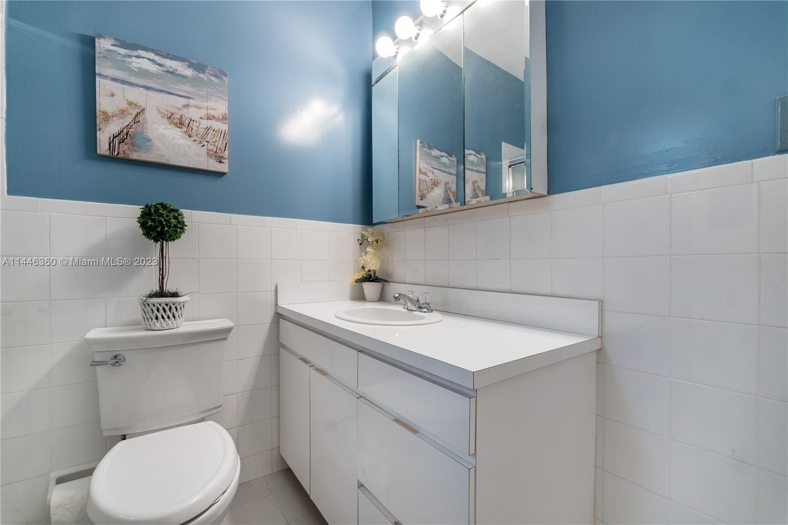 2446 Southwest 15th Street Miami, FL 33145 - Photo 28 of 42 a bathroom with a toilet sink and mirror