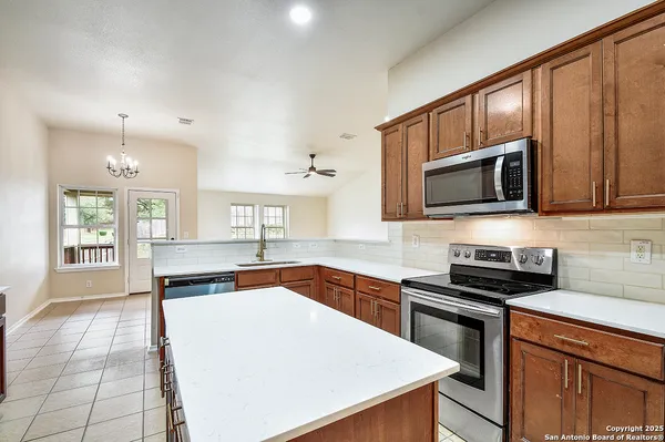 a kitchen with stainless steel appliances a sink stove and cabinets