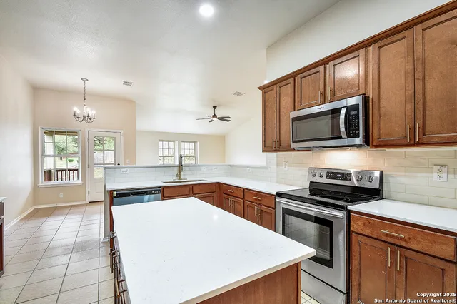 a kitchen with stainless steel appliances a sink stove and cabinets