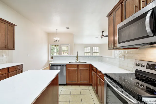 a kitchen with stainless steel appliances a refrigerator and cabinets