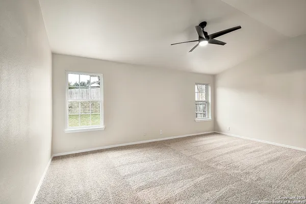 a view of a livingroom with a ceiling fan & entryway