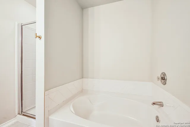 a view of an empty room with a ceiling fan