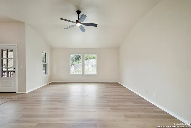a view of a kitchen with a sink and a refrigerator