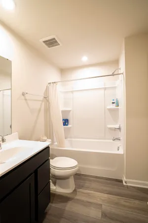a bathroom with a toilet a sink and mirror