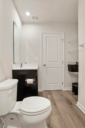 a bathroom with a sink vanity mirror and toilet