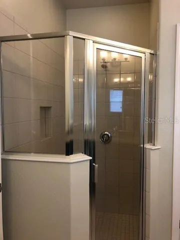 a bathroom with a glass shower door