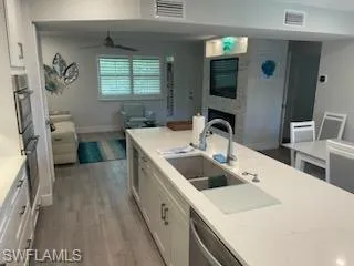 a kitchen with a sink a stove and a refrigerator