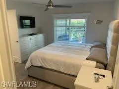 a bedroom with a bed and flat screen tv