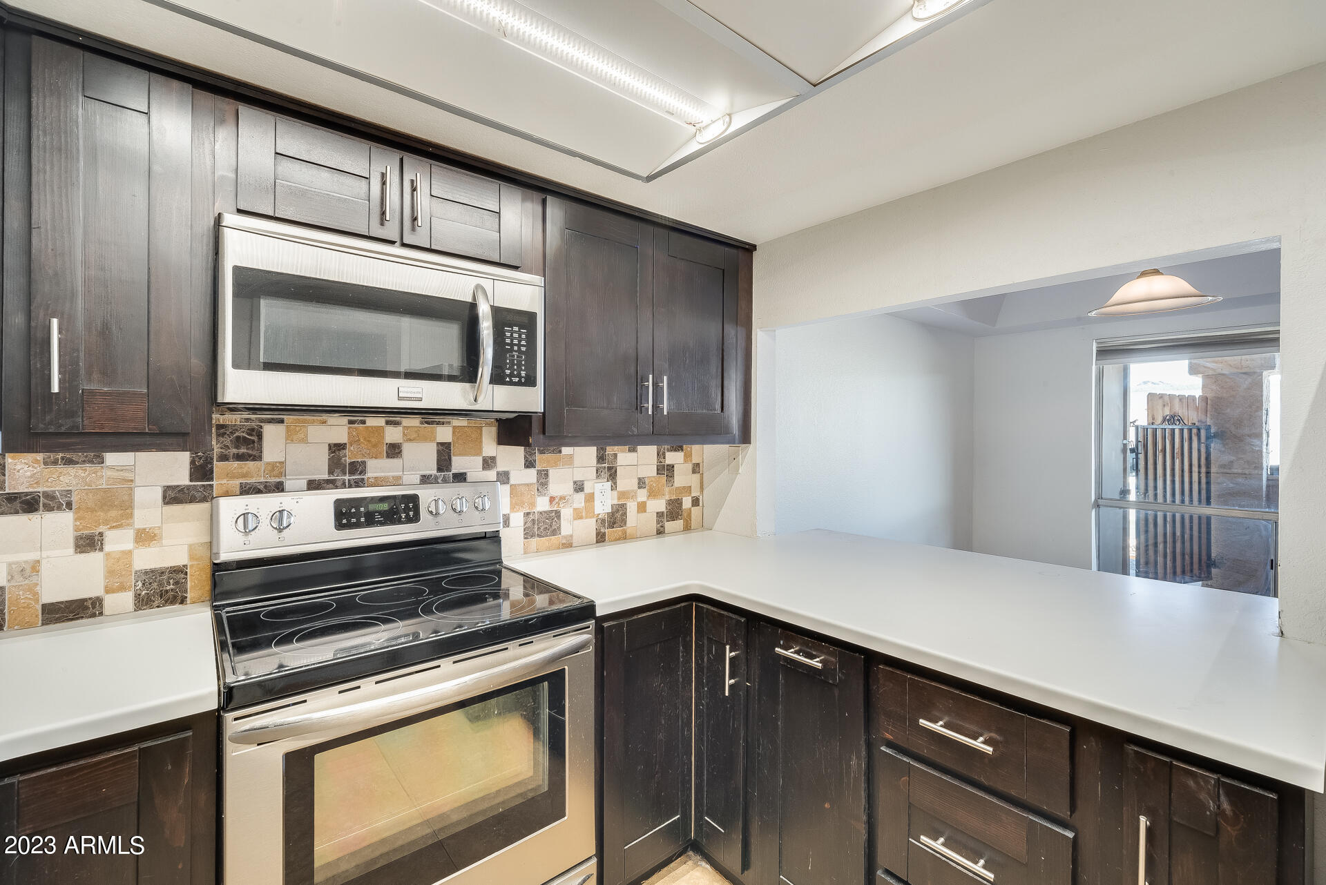 202 East Ruth Avenue, Unit 11 Phoenix, AZ 85020 - Photo 15 of 22 a kitchen with stainless steel appliances a stove microwave and cabinets