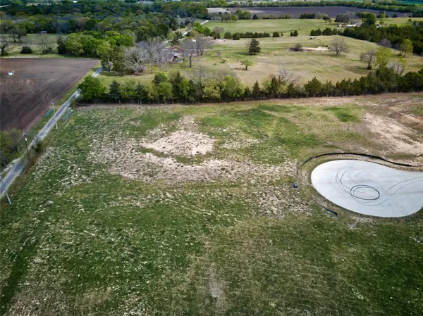 an aerial view of a house with a yard basket ball court and outdoor seating