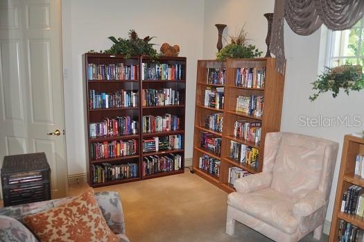 6552 Moorings Point Circle, Unit 102 Lakewood Ranch, FL 34202 - Photo 53 of 57 a living room with furniture and a book shelf