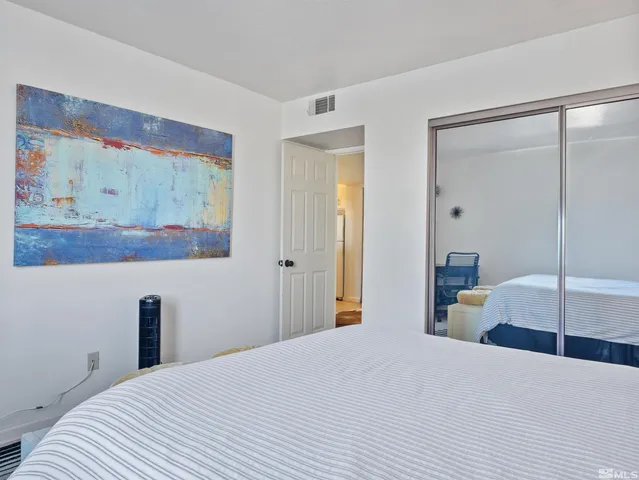 a bedroom with a bed and glass wall