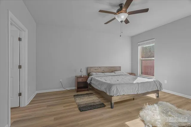 a living room with a bed furniture and a window