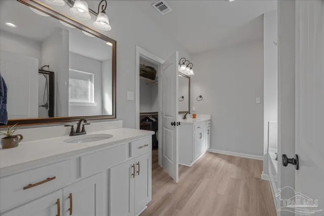 a bathroom with bathtub and shower