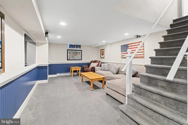 a living room with furniture and stairs