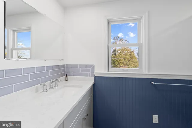 a bathroom with a sink a vanity and a mirror