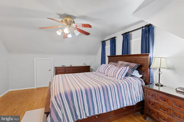 a bedroom with a bed and dresser with mirror