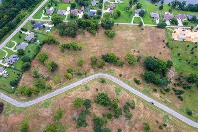 an aerial view of a residential houses with outdoor space