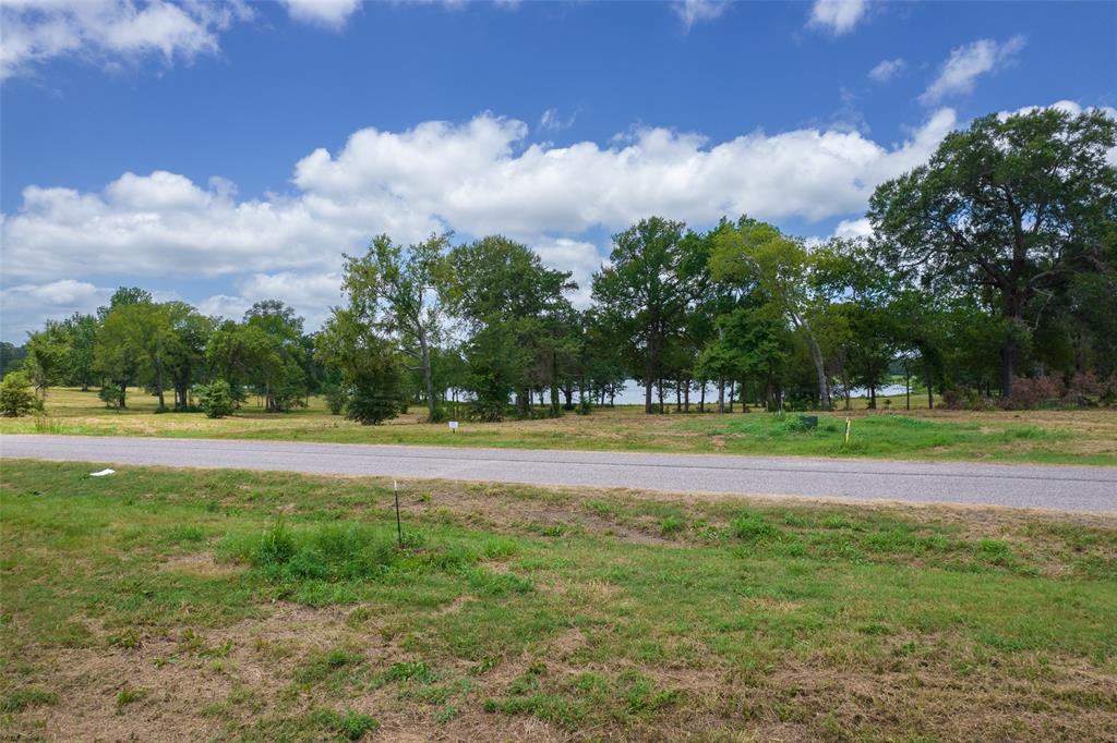 Lot 23-tbd Lot 23-tbd Carolina Way Mount Mount Pleasant, TX 75455 - Photo 7 of 12 a view of swimming pool with a yard and wooden fence