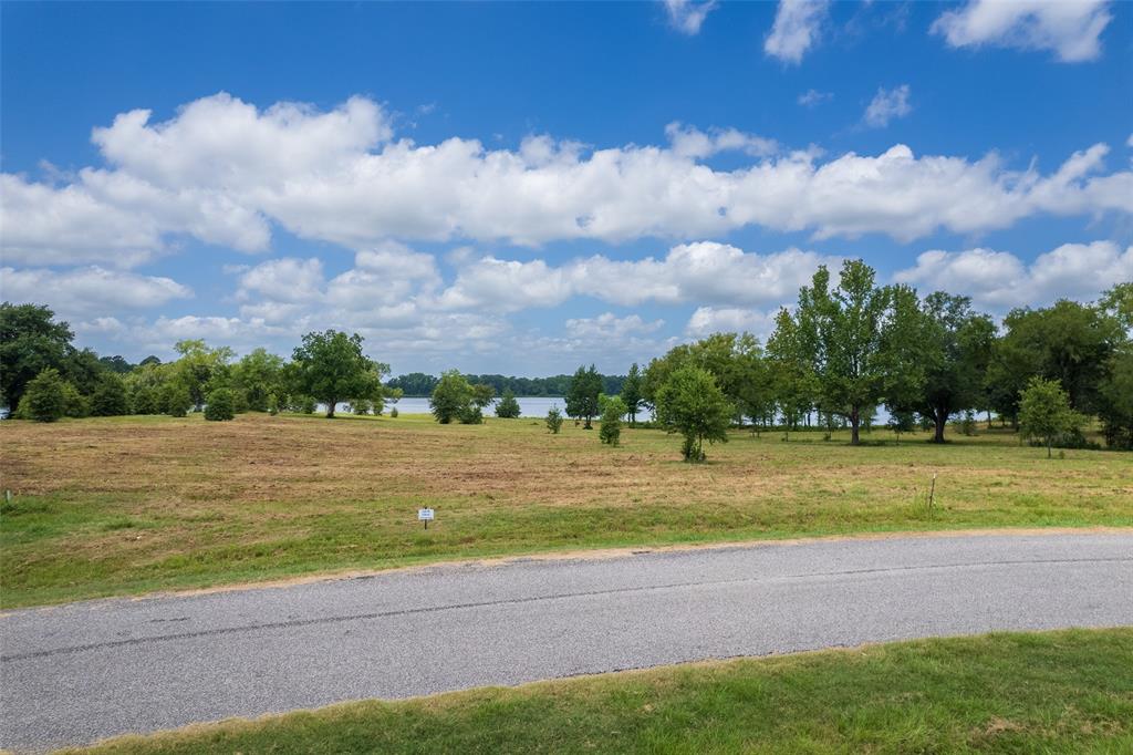 Lot 23-tbd Lot 23-tbd Carolina Way Mount Mount Pleasant, TX 75455 - Photo 9 of 12 a view of a lake and a yard