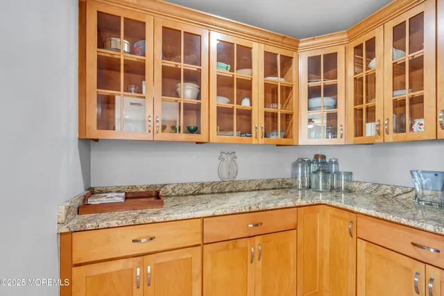 a dining room with furniture and a large window