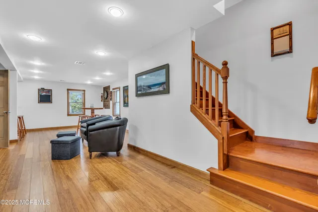 a bathroom with a granite countertop toilet a sink a window and mirror