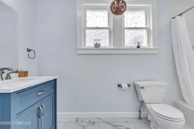 a view of a house with a small yard and wooden floor and fence