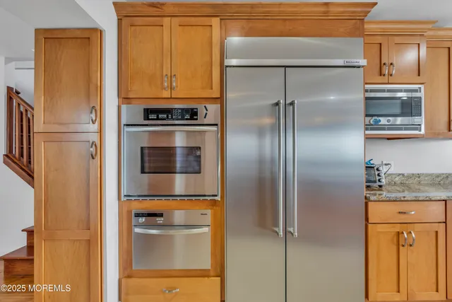 a bedroom with furniture and a large window