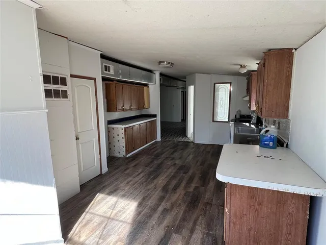a kitchen with a sink appliances and cabinets