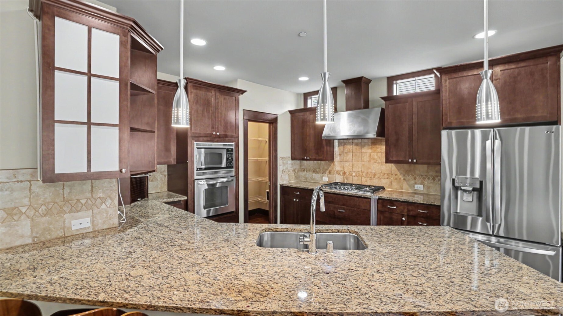 1357 Elma Place Northeast Renton, WA 98059 - Photo 31 of 40 a kitchen with stainless steel appliances granite countertop a refrigerator and a stove top oven
