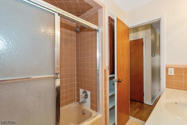 a bathroom with a shower and a tub