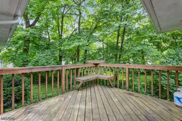 a view of balcony with wooden floor and fence