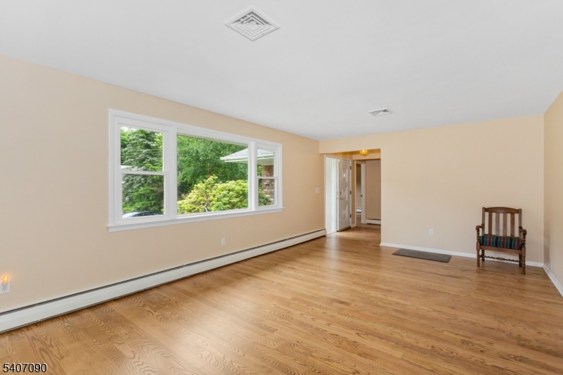 3 Mulberry Terrace Kinnelon, NJ 07405 - Photo 5 of 38 a view of an empty room with window and wooden floor