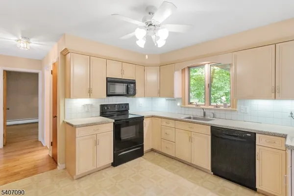 a kitchen with a sink stove and microwave