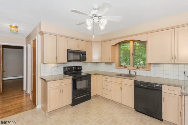 a kitchen with a sink stove and microwave