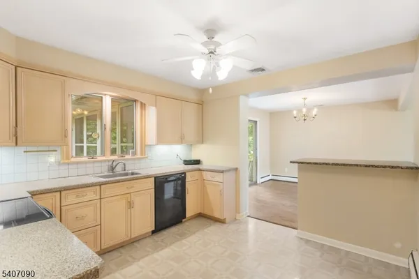 a large kitchen with a large window appliances and cabinets