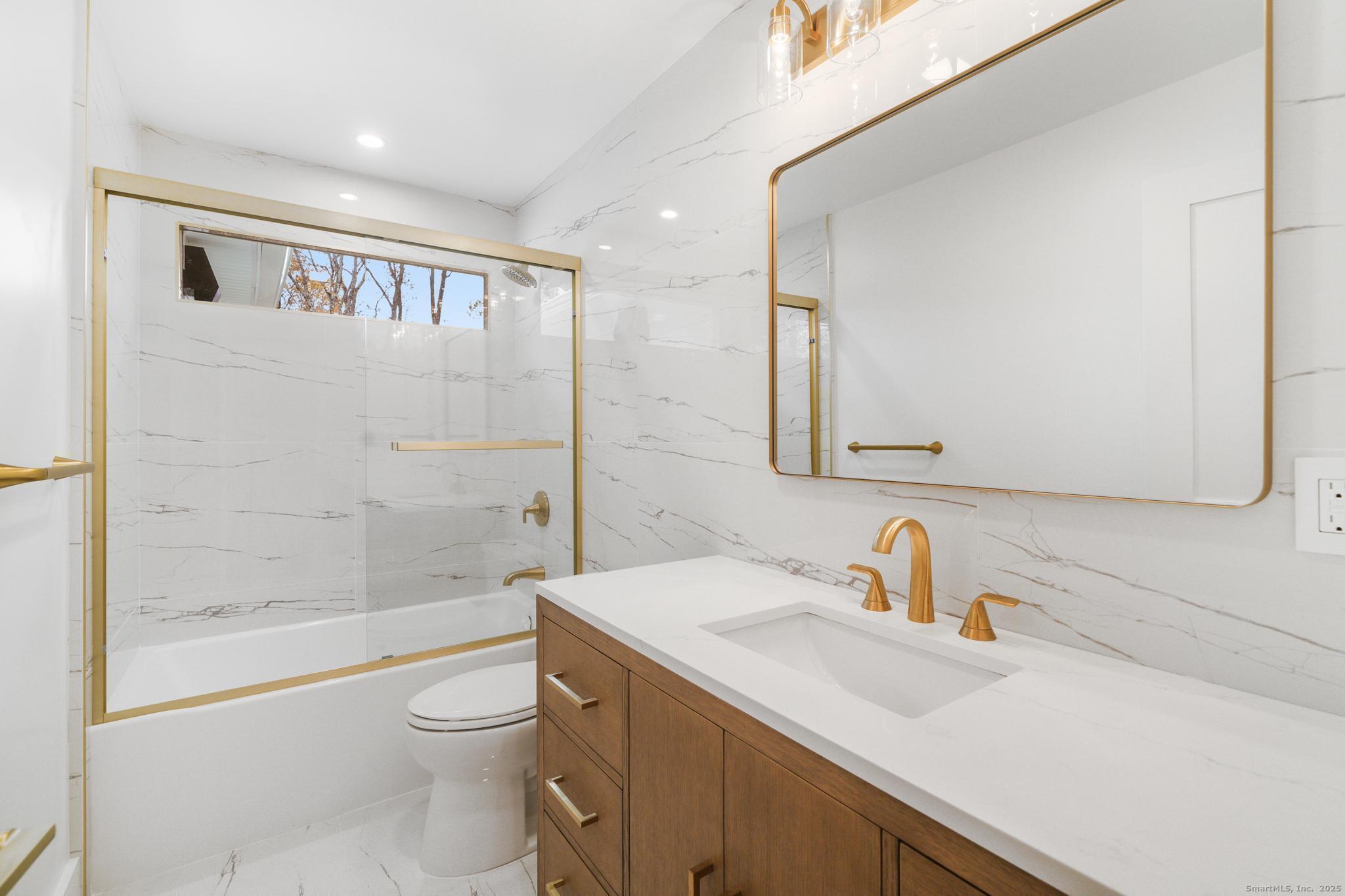 55 Liberty Street Wilton, CT 06897 - Photo 12 of 23 a bathroom with a sink a toilet and shower