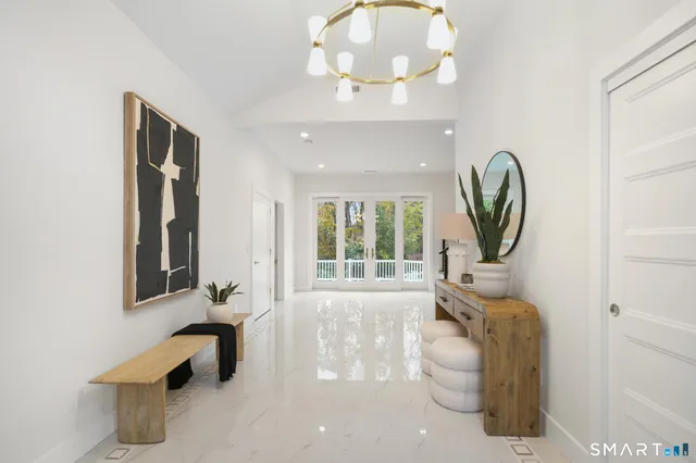 a living room with furniture and a large mirror