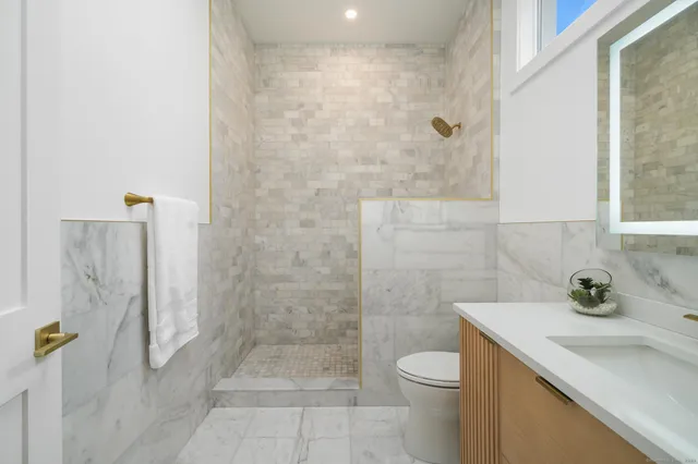 a bathroom with a sink toilet and shower