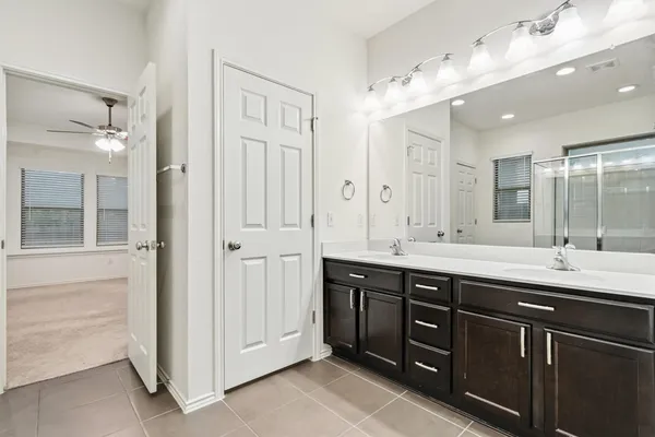 a bathroom with a double vanity sink mirror and double