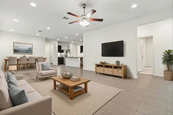 a living room with furniture and a flat screen tv